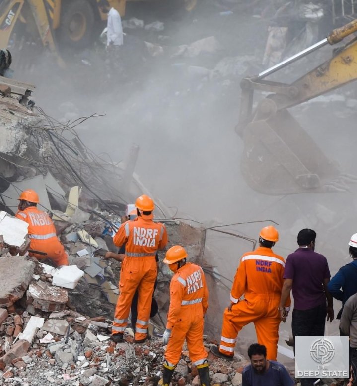 Rescue personnel search through the rubble of the collapsed building near Saket Metro Station as emergency teams continue recovery operations